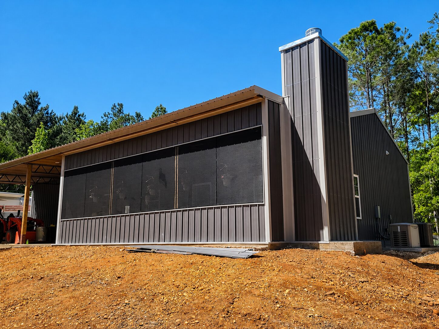 Tan barndominium with a large covered patio