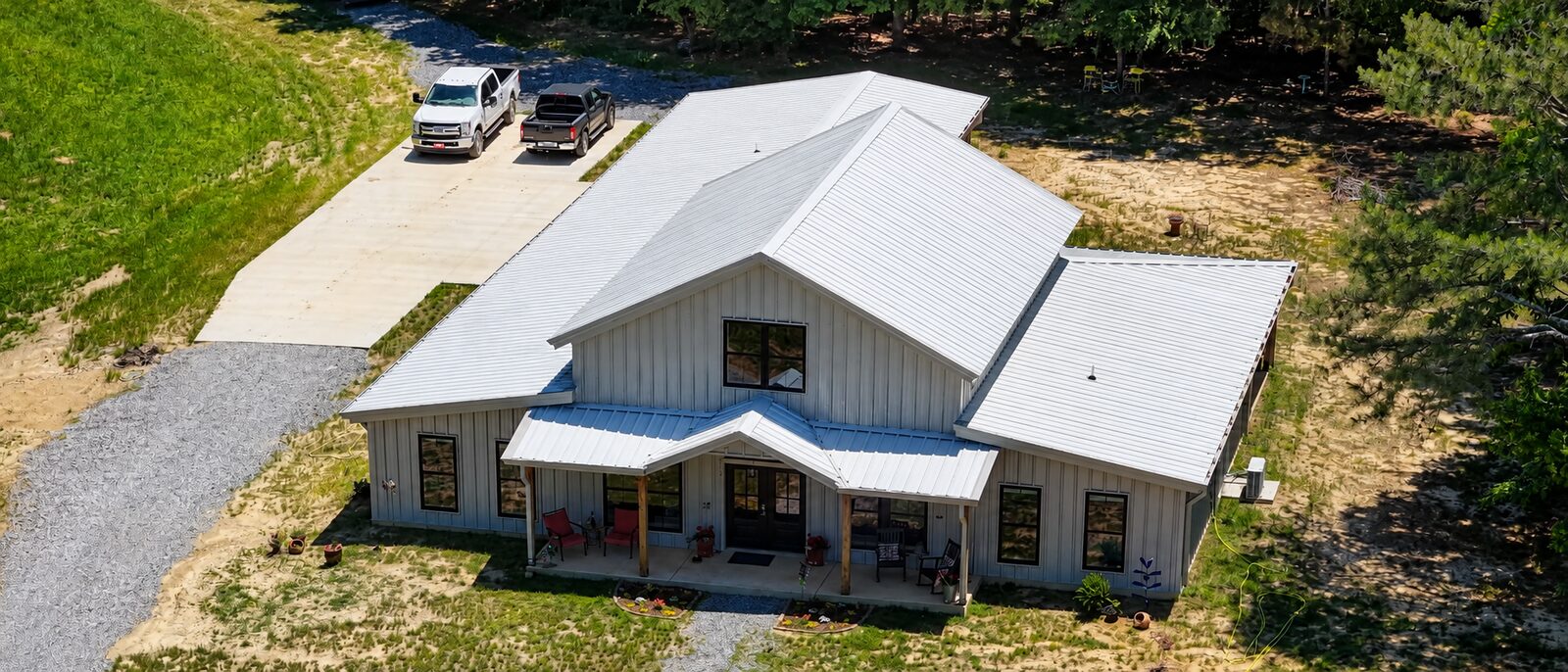 White barndominium home with metal roof