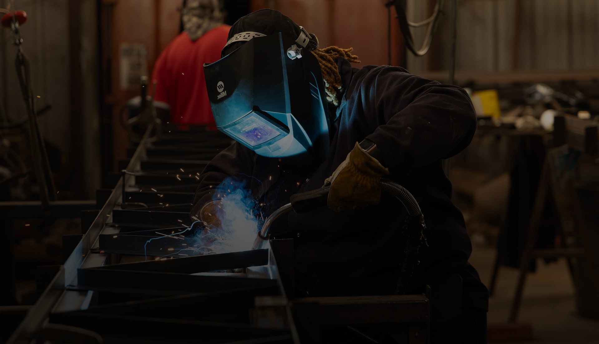 Welder fabricating steel inside the Alabama Steel Supply shop